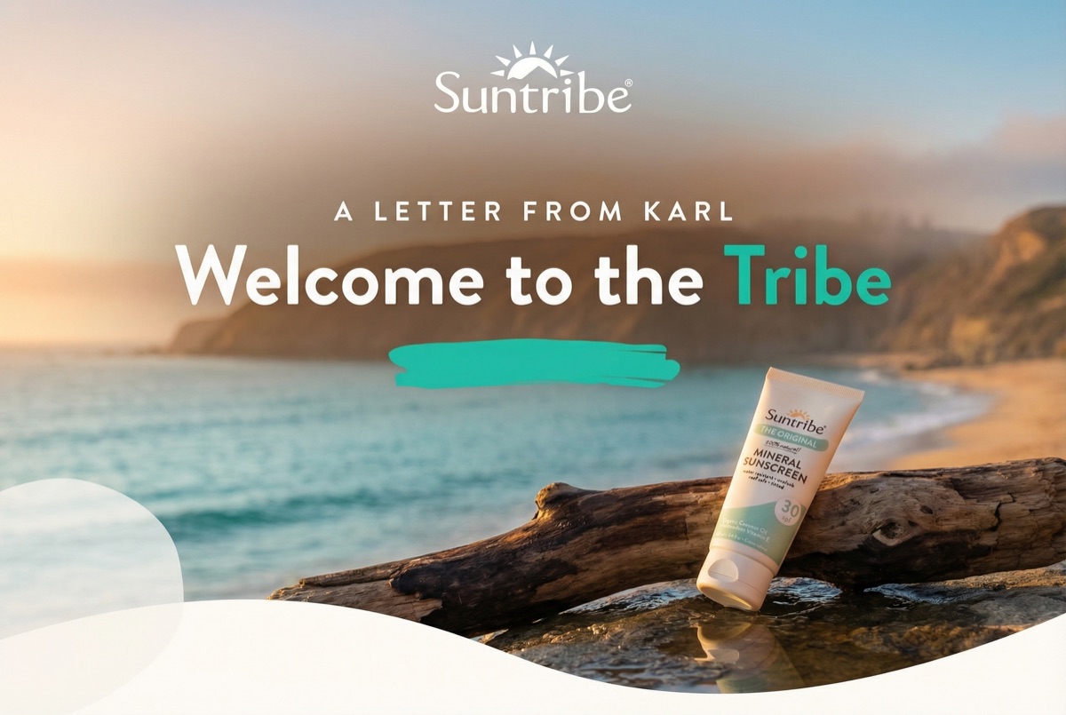 Welcome to the Tribe - Suntribe sunscreen on driftwood by the ocean at golden hour